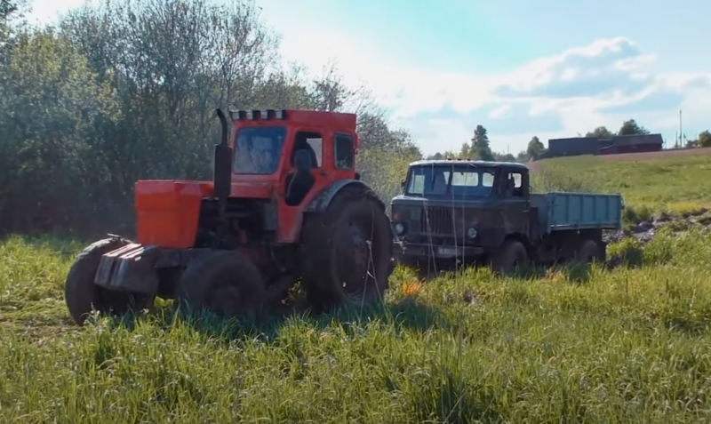 Soviet off-road equipment - a GAZ-66 truck against a T-40AM tractor in a swamp